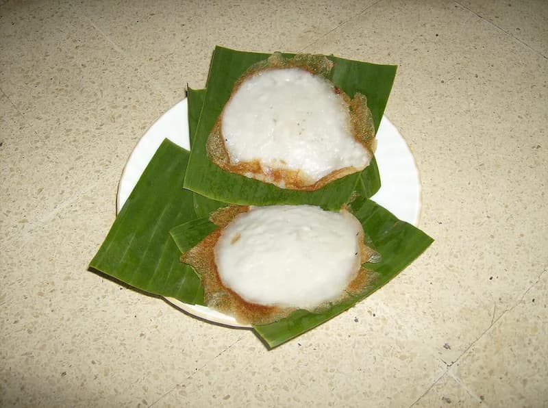 Dua serabi Solo dengan bagian tengah putih lembut dan pinggiran renyah kecokelatan di atas daun pisang